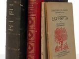 three books that are sitting on a white table