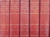 several red books are lined up on a shelf in a library
