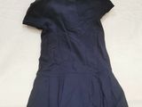 the back of a blue dress on a white surface