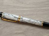 a pen that is laying on a wooden table