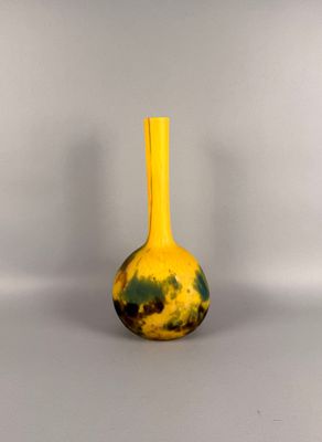 a yellow vase with a black and yellow design on it