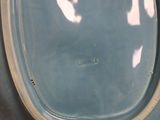 a close up of a blue plate with a hole in it