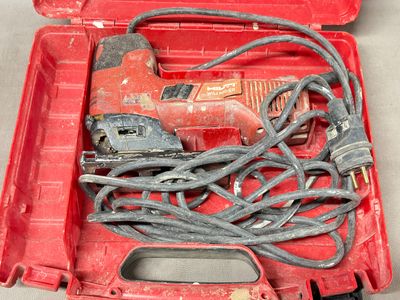 a red tool box with tools in it on a table