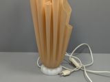 a lamp that is sitting on a table next to a wall