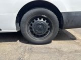 a white van with a flat tire parked in a parking lot