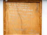 a sign on the door of a building that has writing on it