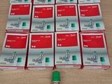 a lot of red and white boxes with a green valve on a table