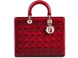 a red handbag with a metal handle on a white background