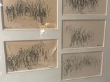 a picture of a group of drawings hanging on a wall