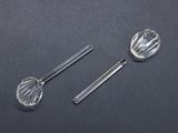 two silver spoons and a measuring spoon on a black surface