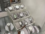 many watches on display in a glass case