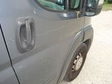an image of a van door handle with a dog sticking out of it