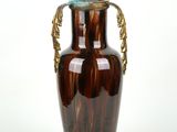 a brown vase with a gold handle on a white background