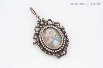 a close up of a necklace with a picture of a woman on it