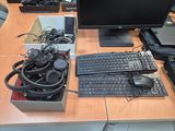 a desk with a computer, keyboard, mouse, and headphones on it