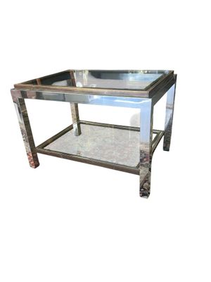mirrored coffee table with metal legs and a glass top