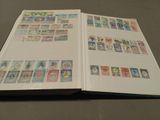 an open book with stamps on it sitting on a table