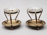 paire de bougeoirs plaqués argent avec des supports en verre sur des socles