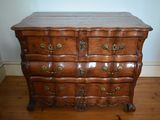 a wooden chest of drawers on a hard wood floor