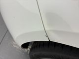 a close up of a white car with a flat tire