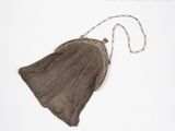 brown knitted purse on white background with chain