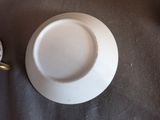 a white plate and a cup sitting on a table