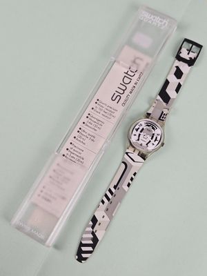 a watch that is sitting on a table next to a ruler
