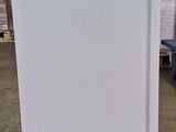 an image of a white refrigerator in a warehouse