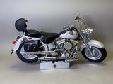 a white motorcycle with a black helmet on it