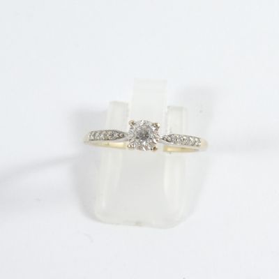 a close up of a diamond ring on a white surface
