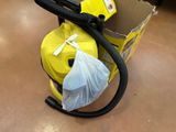 a bag of trash sitting on the floor next to a blower