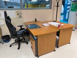 a desk with a chair and a laptop on it