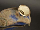 a close up of a vase with a cup on it