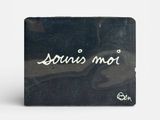 a picture of a black business card holder with the word louis mou written on it