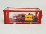 a red toy car in a clear box with a sale price sign on it
