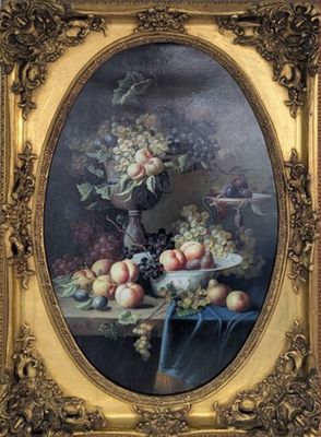 tableau représentant une nature morte avec des fruits sur une table, dans un cadre doré