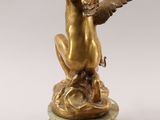an antique bronze statue of an angel sitting on top of a marble base