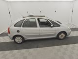 a picture of a small white car in a garage