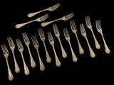 a lot of forks and spoons on a black background