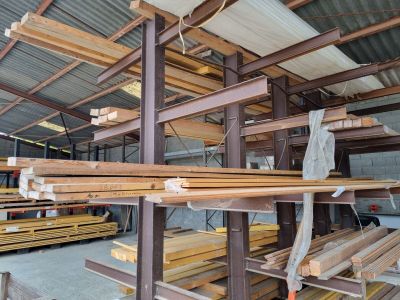 many pieces of wood stacked up in a warehouse