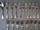 a lot of forks and spoons that are on the table