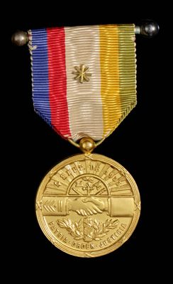 gold medal with a red, white, blue, yellow, and red ribbon