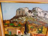 a picture of a painting of a mountain in a gold frame
