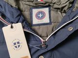 the jacket is blue and has a tag attached to it