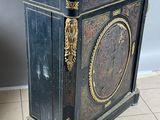 a black and gold cabinet with a marble top