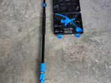 a blue pole and a tool on the floor