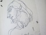drawing of a woman ' s face in a book with a pencil