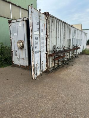 a large white container sitting in the middle of a parking lot