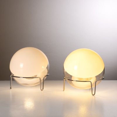 pair of modern table lamps sitting on top of a white table