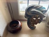 a statue of a woman wearing a turban next to a vase